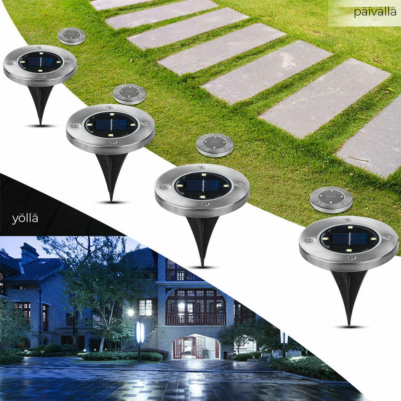 "Aurinkoenergialla toimivat LED-polkuvalot puutarhaan, hopeinen runko, lämpimän valkoiset LEDit, istutettuna nurmikolle."